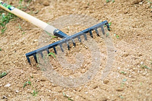 Working In Garden With Rake Leveling Ground. Work In Garden With Rake. Preparation Of Ground For Seeding and Planting