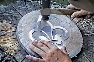 Working with hammer during hand stamping or engraving decoration pattern on metal ornamen