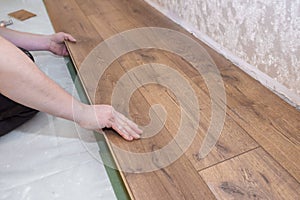 Working hands lay the wooden parquet floor. Repair of wooden floors, repair concept