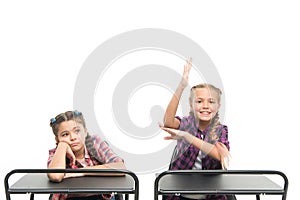 Working hard on their knowledge. Adorable small schoolchildren passing knowledge test at school desks. Knowledge and