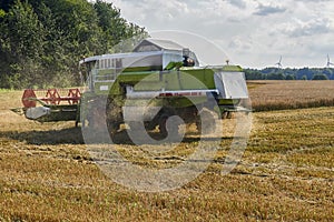 Working Harvesting Combine in the Field of Wheat