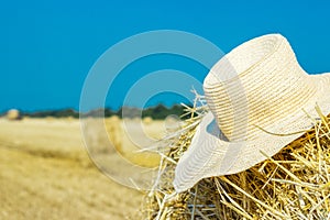 Working hat of a farmer on a haystack. Agriculture Concept.Harvest concept