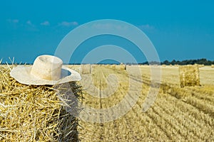 Working hat of a farmer on a haystack. Agriculture Concept.Harvest concept