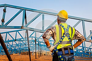 Working at height equipment in construction site. Fall arrestor device for worker with hooks for safety body harness on selective