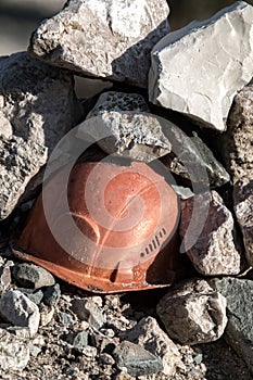 Working helmet on a pile of stones