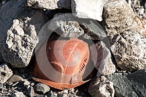 Working helmet on a pile of stones