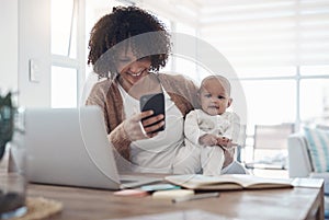 Working her way to a financially secure future. Shot of a young woman using a smartphone and laptop while caring for her