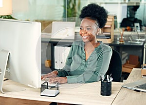 Working her way towards big results. a young businesswoman working on a computer in an office.