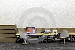 Working from home concept, with cardboard furniture in a doll house