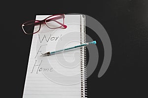 Working from home concept with  notepad with workfrom home written on a dining table
