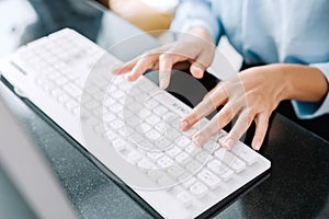 Working at home with laptop woman writing a blog. Female hands on the keyboard