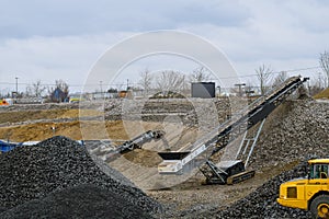 working industrial equipment of a crushing and processing plant in a plume