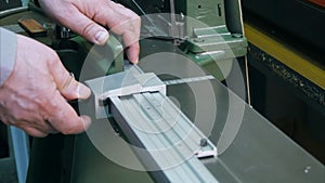 Working on industry machine, cutting frame in workshop