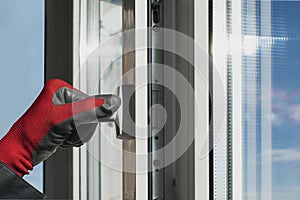 A working installer checks the window frame