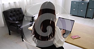 A working Japanese woman typing laptop by remote work in the home office closeup