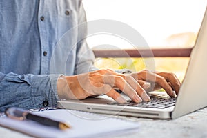 working on laptop, close up of hands of business man.