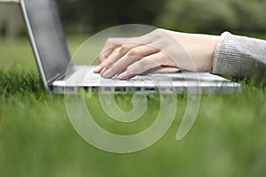 Working on a laptop in the grass