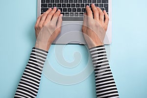 Working on laptop. Woman working on computer. Woman`s hands typing on laptop.