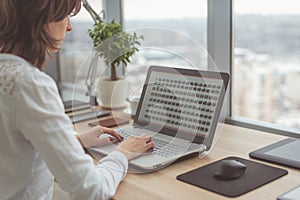 Working with laptop woman writing a blog. Female hands on the keyboard.