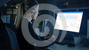 Working Late at Night in the Office: Businesswoman Using Desktop Computer, Using Headsets and Maki