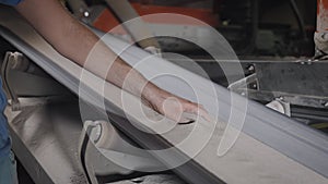 A working man checks the quality of the sand-clay mixture. Conveyor line with raw materials in production.