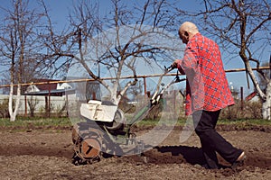 Working man with motor cultivator