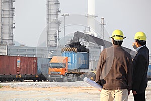 Working man and oil plant