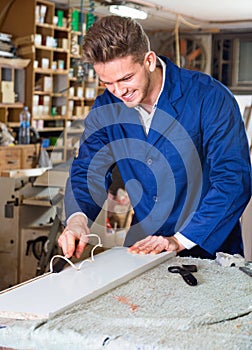 Working man practising his skills in plank chiseling