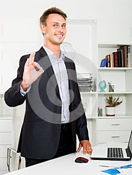 Working man satisfied with agreement in company office