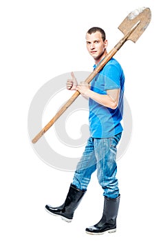 Working man with a shovel goes to dig on a white