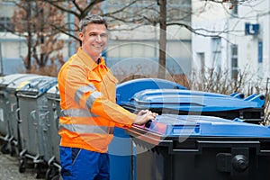 Working Man Standing Near Dustbin On Street