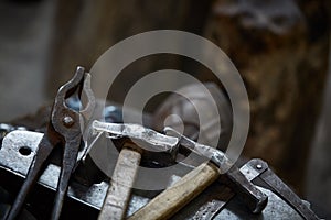 Working metal tools in blacksmith`s workshop, close-up, selective focus, nobody