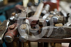 Working metal tools in blacksmith`s workshop, close-up, selective focus, nobody