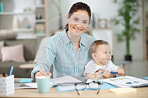 working mom with baby in lap