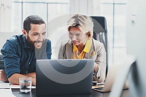 Working moments. Group of young coworkers people in casual wear discussing business ideas while working in the office. photo