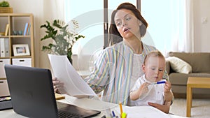 Working mother with baby boy at home office