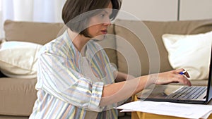 Working mother and baby boy playing at home office