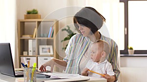Working mother with baby calling on smartphone