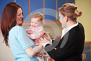 Working Mother Dropping Child Off At Nursery photo