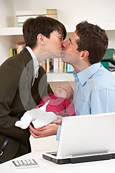 Working Mother Leaving Baby With Father