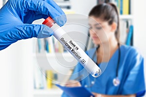 Working nurse with test tube of Omicron variant photo