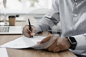 Working in office, businessman employee signing contract agreement closeup.