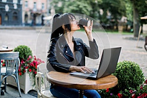 Working online, freelance concept. Young pretty smart Asian woman enjoying the coffee-break, using laptop computer