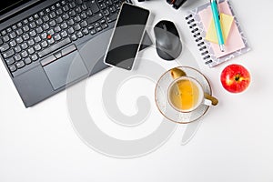 Working place and office desk with coffee, apple, laptop, headset and smarthpone