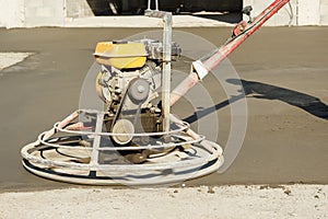 Working power trowel machine on a fresh concrete surface