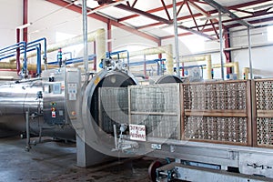 Working process of the production of green peas on cannery. Pasteurization in autoclave photo