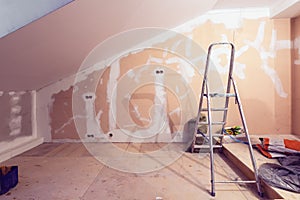 Working process of renovate room with installing drywall or gypsum plasterboard and ladder with construction materials