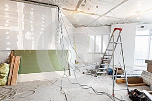 Working process of renovate room with installing drywall or gypsum plasterboard and ladder with construction materials