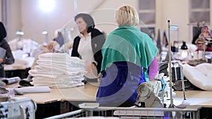 Working process at a textile factory. Women work in a sewing workshop. Modern textile factory