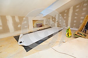 Working process of wallpapering on the drywall in small room apartment is under construction, remodeling, renovation